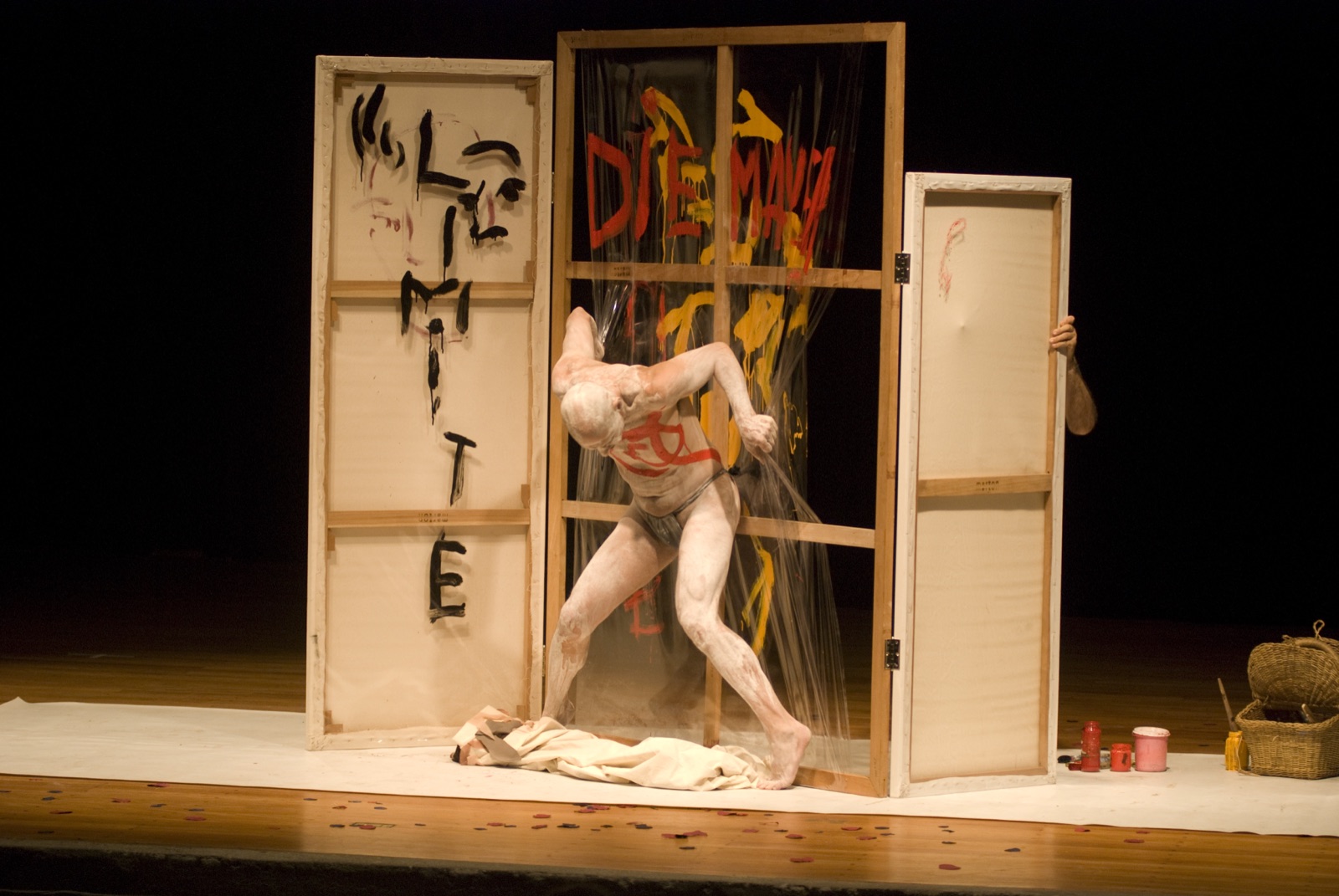 José Maria Carvalho performing within a painted stage environment.
